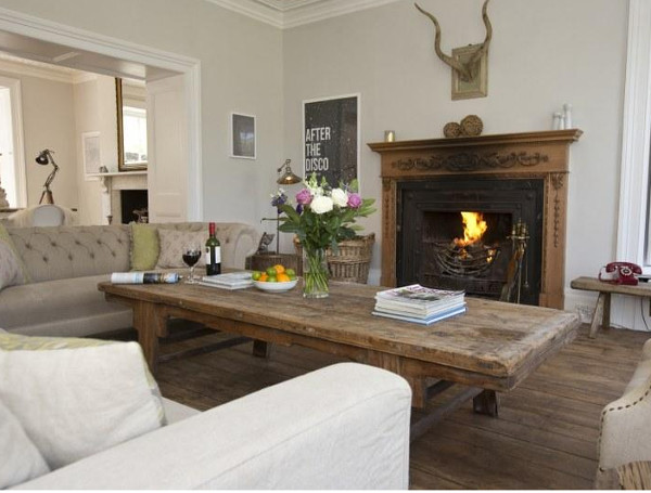 The living room with an open fire at this cottage in Low Road