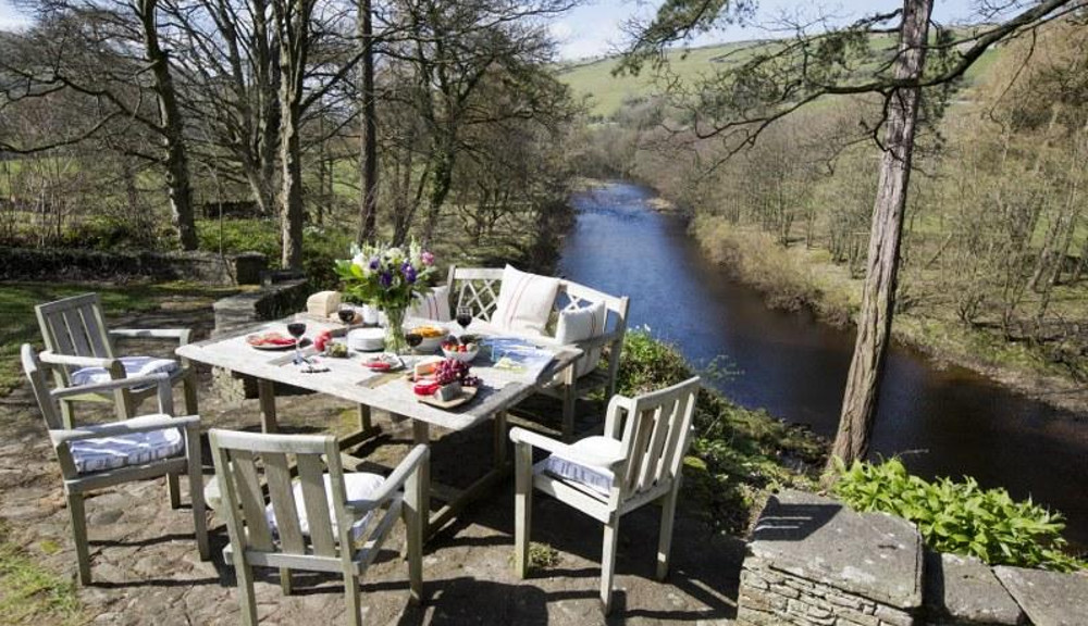 Outside this cottage, by the river