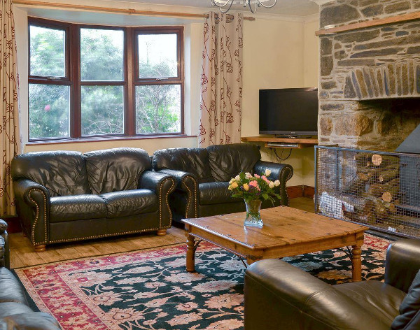 Living room with the wood burning stove in Sherrill Farmhouse at Sherrill Farm Holiday Cottages, Dunterton