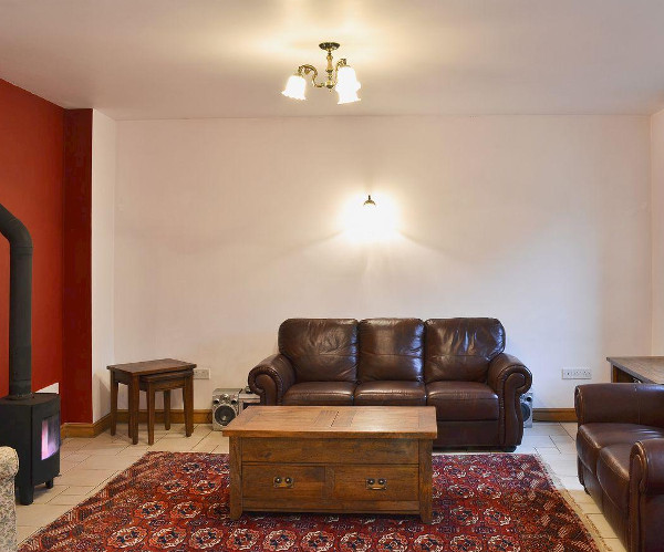 The living room and wood burning stove at Trinity Stables in Buxton